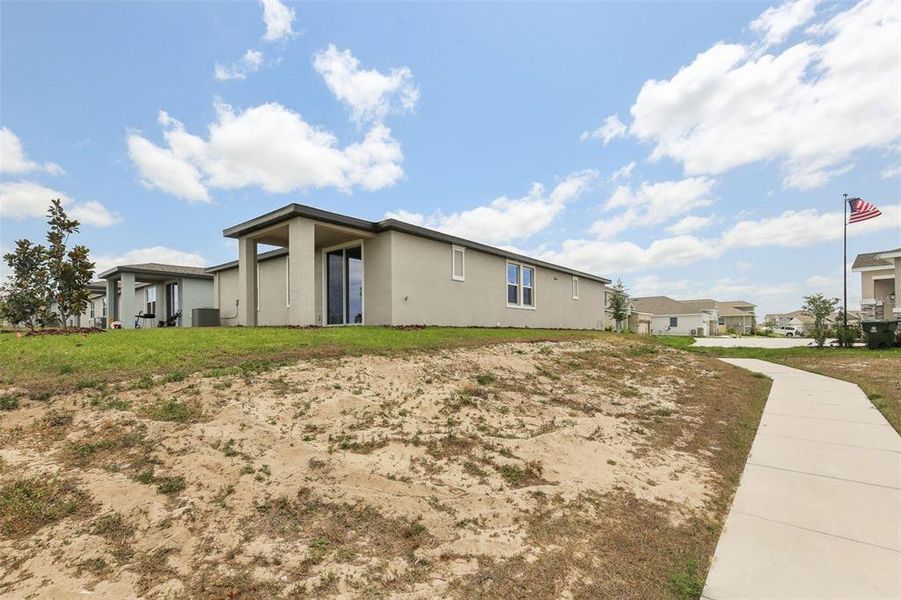 Front exterior of a new home in Eden Hills, Lake Alfred, FL, highlighting curb appeal (Image 17).
