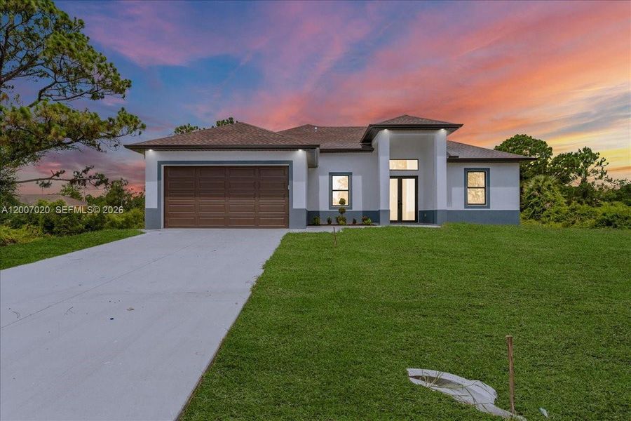 Front exterior of a new home in , Lehigh Acres, FL, highlighting curb appeal (Image 26).