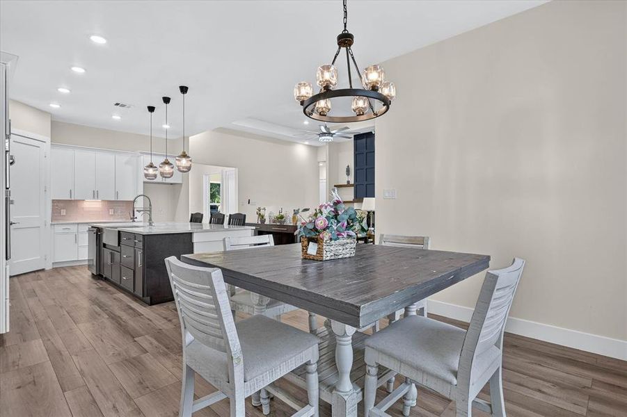 Open-concept living space featuring wood-finish flooring Open-concept living space featuring wood-finish flooring