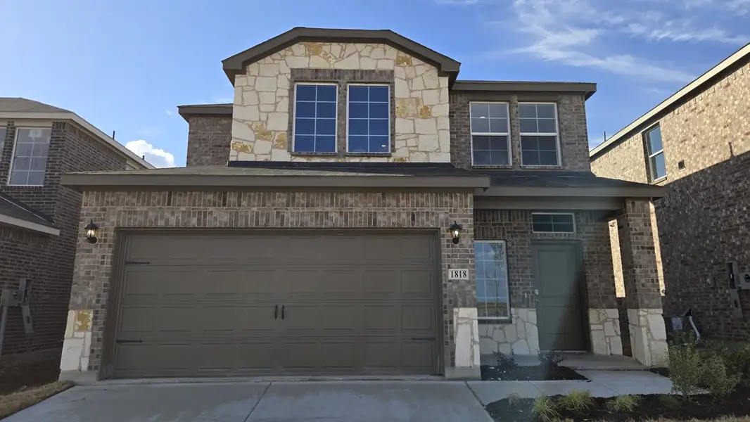 Front exterior of a new home in Creekside Ranch, Blue Ridge, TX, highlighting curb appeal (Image 1).