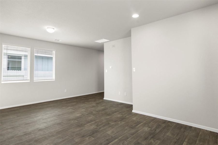 Empty room featuring dark wood-style floors and recessed lighting Empty room featuring dark wood-style floors and recessed lighting