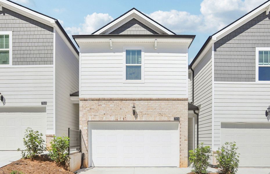 Front exterior of a new home in Artisan Walk, Fairburn, GA, highlighting curb appeal (Image 1). Front exterior of a new home in Artisan Walk, Fairburn, GA, highlighting curb appeal (Image 1).