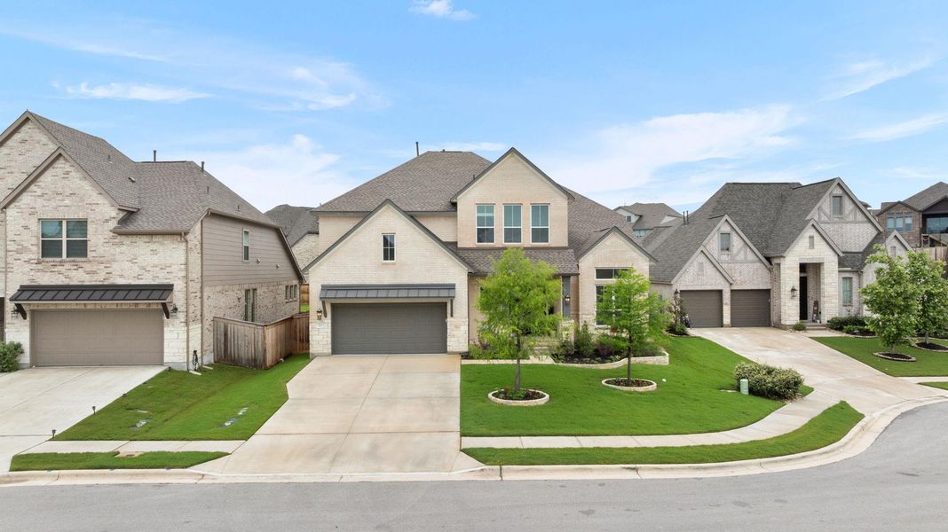 Elegant brick and stone facade adorns this residence with a well-maintained lawn.