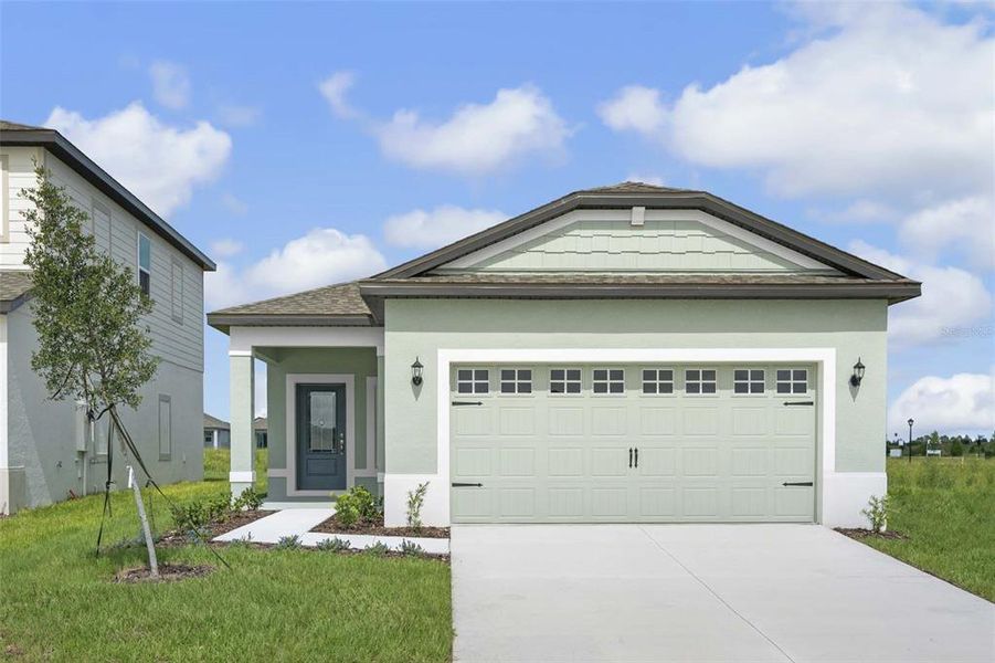 Front exterior of a new home in Gum Lake Preserve, Lake Alfred, FL, highlighting curb appeal (Image 1). Front exterior of a new home in Gum Lake Preserve, Lake Alfred, FL, highlighting curb appeal (Image 1).