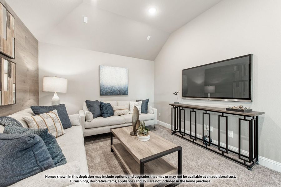 Living room with vaulted ceiling, two gray sofas, large wall-mounted TV, and wood coffee table on carpet Living room with vaulted ceiling, two gray sofas, large wall-mounted TV, and wood coffee table on carpet