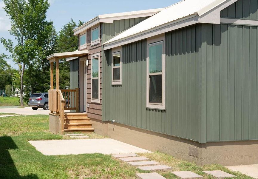 View of property exterior with crawl space and a yard View of property exterior with crawl space and a yard