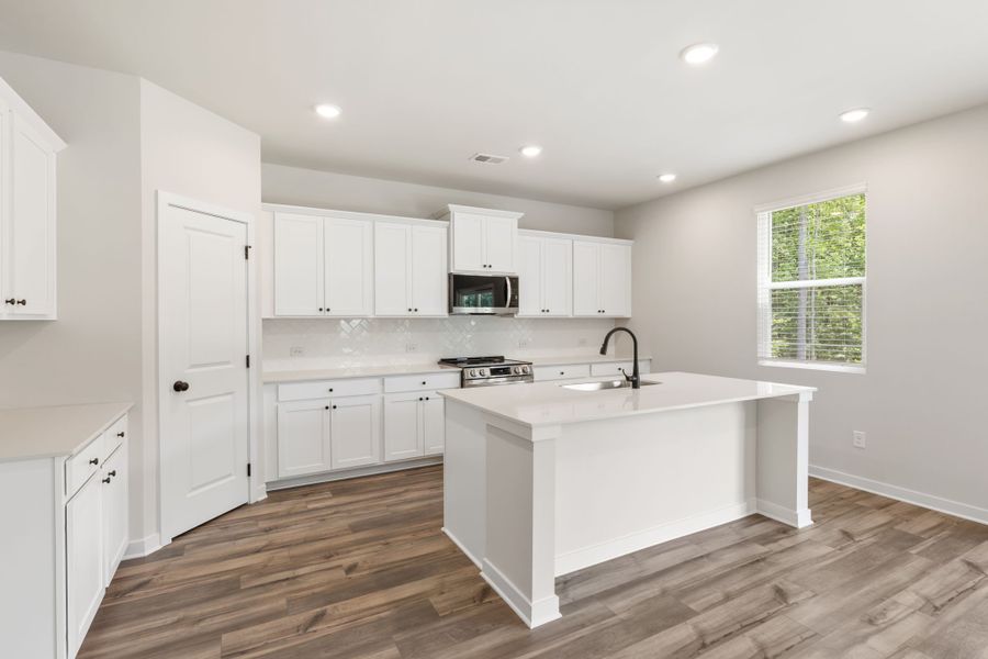 A kitchen with white cabinets. A kitchen with white cabinets.