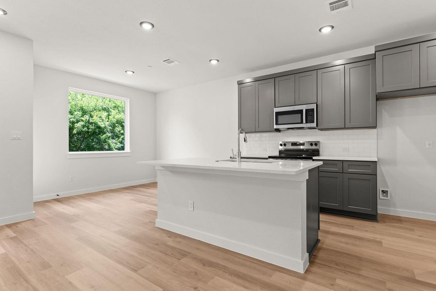 A well-appointed kitchen island anchors this inviting living space with bright natural light.