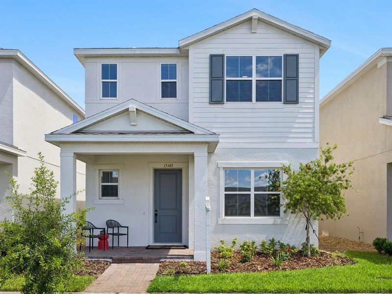 Front exterior of a new home in Osprey Ranch, Winter Garden, FL, highlighting curb appeal (Image 27).