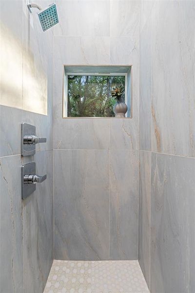 Bathroom featuring a tile shower