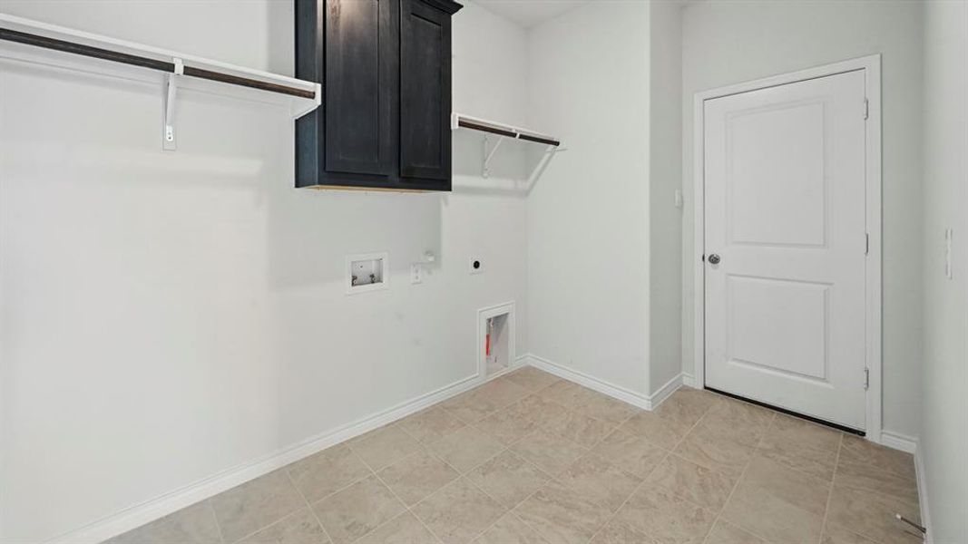 Laundry room featuring cabinet space, hookup for an electric dryer, hookup for a washing machine, and hookup for a gas dryer