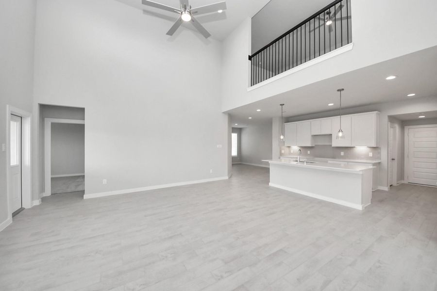 Family room flooded with natural light through the expansive windows. The premium tile flooring adds a touch of luxury to the space, creating the perfect setting for relaxing moments and cherished gatherings with loved ones. Sample photo of completed home with similar floor plan. Actual colors and selections may vary. Family room flooded with natural light through the expansive windows. The premium tile flooring adds a touch of luxury to the space, creating the perfect setting for relaxing moments and cherished gatherings with loved ones. Sample photo of completed home with similar floor plan. Actual colors and selections may vary.