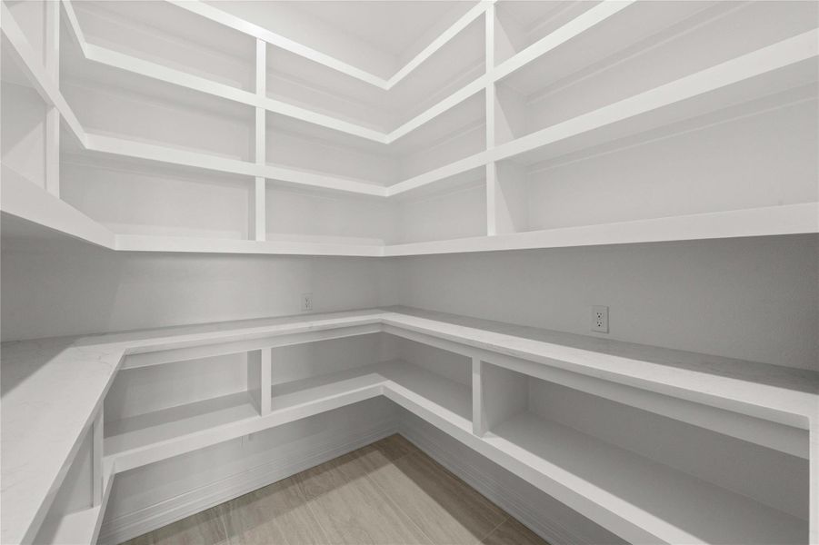 Ample built-in shelving provides generous storage space in this organized pantry. Ample built-in shelving provides generous storage space in this organized pantry.
