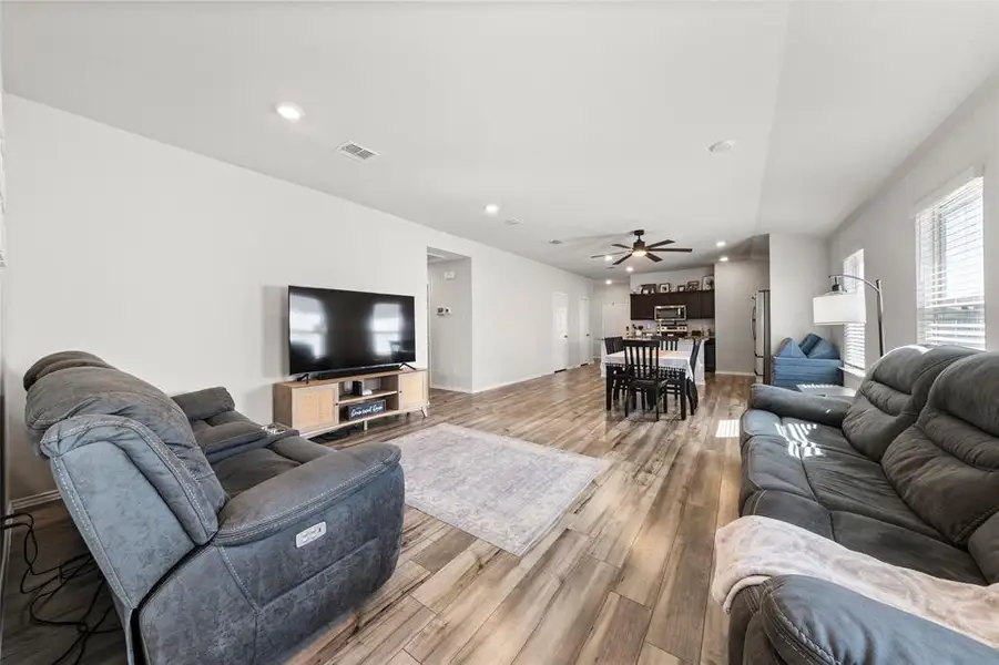 Living room featuring recessed lighting, light wood-style flooring, and ceiling fan