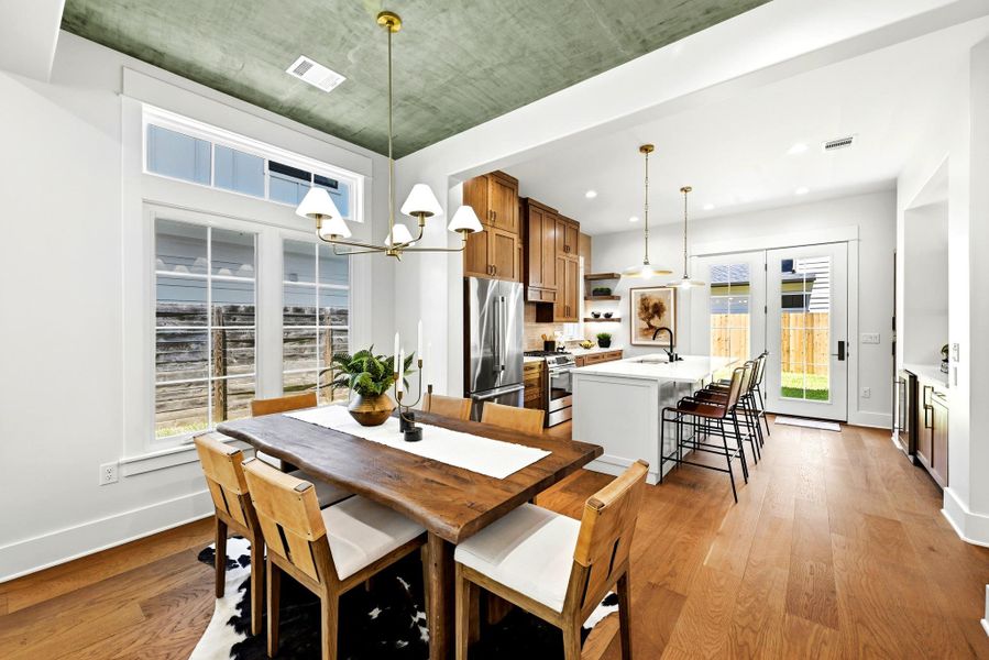 An open-concept living space presents a modern kitchen and dining area, complete with hardwood floors. An open-concept living space presents a modern kitchen and dining area, complete with hardwood floors.