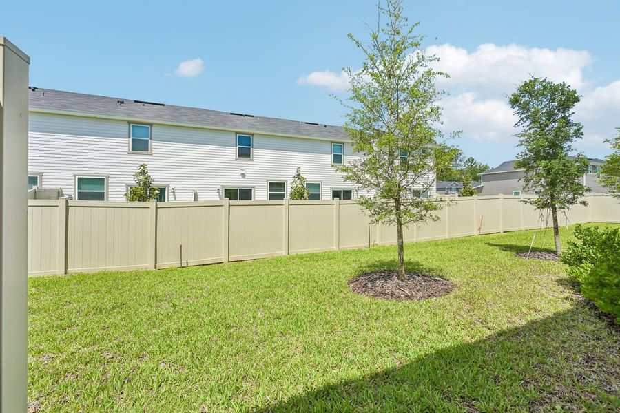 Exterior details and patio area of a home in Orchard Park Townhomes, St. Augustine (Image 4).