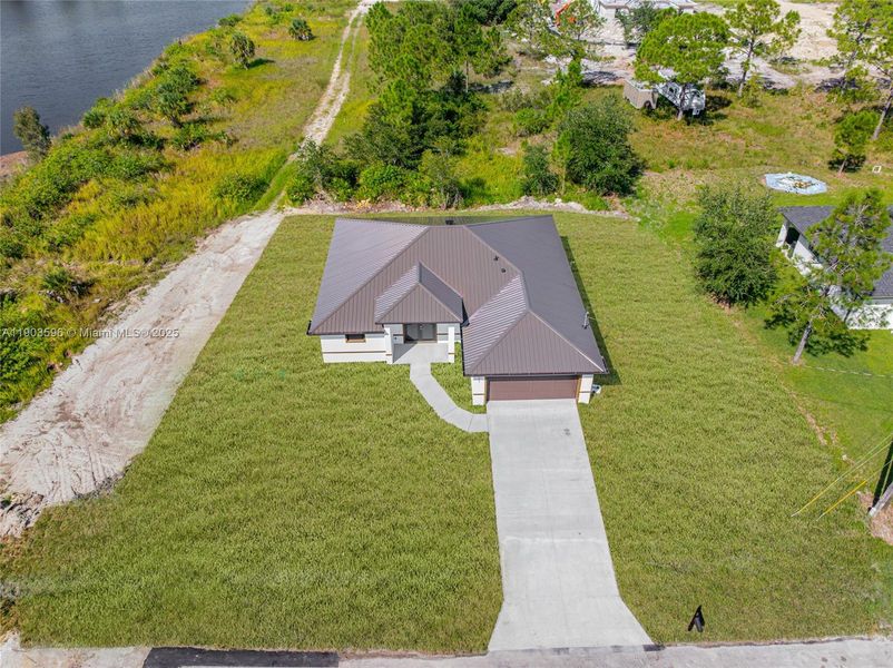 Front exterior of a new home in , Lehigh Acres, FL, highlighting curb appeal (Image 22).