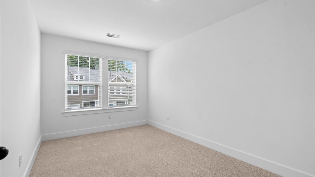 Accomplished design in this restful bedroom featuring plush carpet and oversized window views Accomplished design in this restful bedroom featuring plush carpet and oversized window views