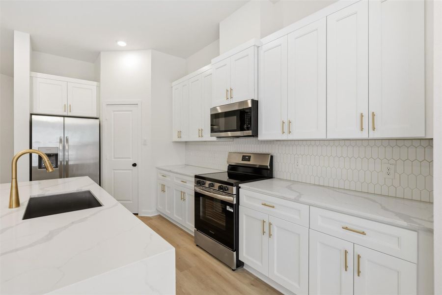 Notice the geometric backsplash. Neutral enough to match any design while adding a touch of elevation.