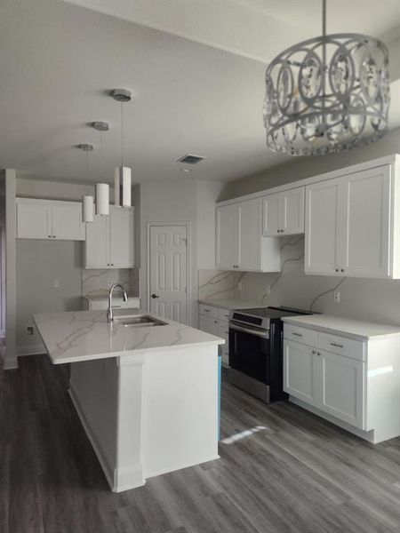 Kitchen featuring pendant lighting, white cabinets, stainless steel electric range, and dark wood-style flooring Kitchen featuring pendant lighting, white cabinets, stainless steel electric range, and dark wood-style flooring