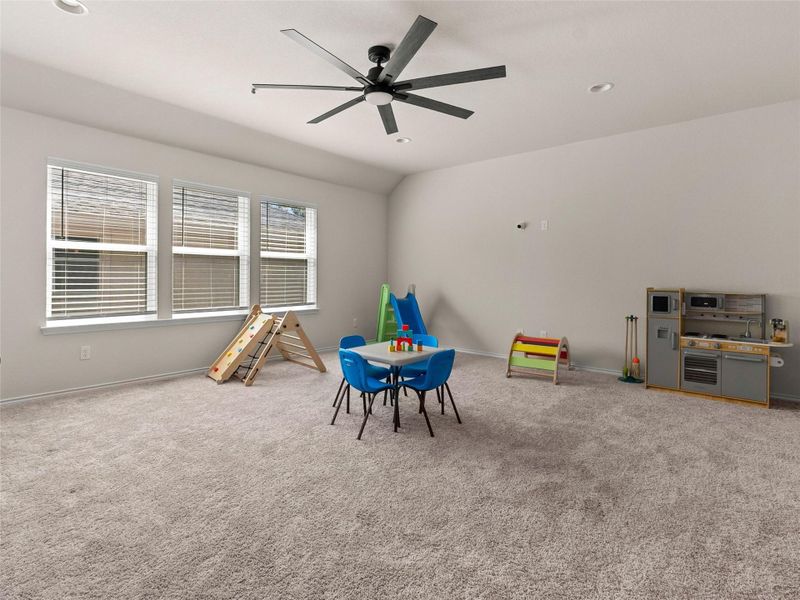 Rec room featuring ceiling fan, light carpet, vaulted ceiling, and recessed lighting