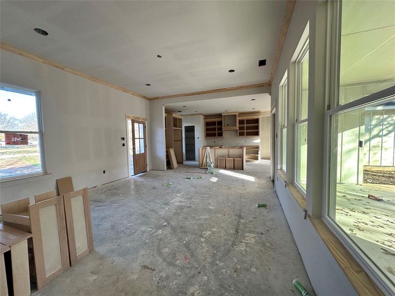 Unfurnished living room featuring ornamental molding