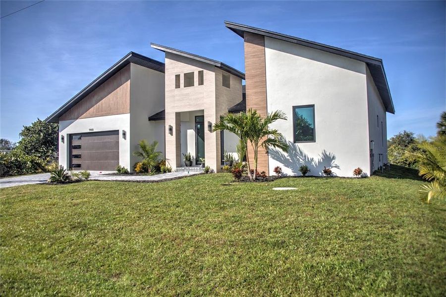 Front exterior of a new home in , Port Charlotte, FL, highlighting curb appeal (Image 28). Front exterior of a new home in , Port Charlotte, FL, highlighting curb appeal (Image 28).
