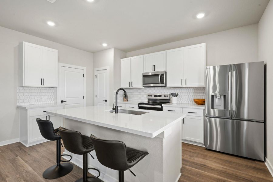 A spacious kitchen design integrates modern cabinetry, smooth stone surfaces, and durable wood flooring. A spacious kitchen design integrates modern cabinetry, smooth stone surfaces, and durable wood flooring.