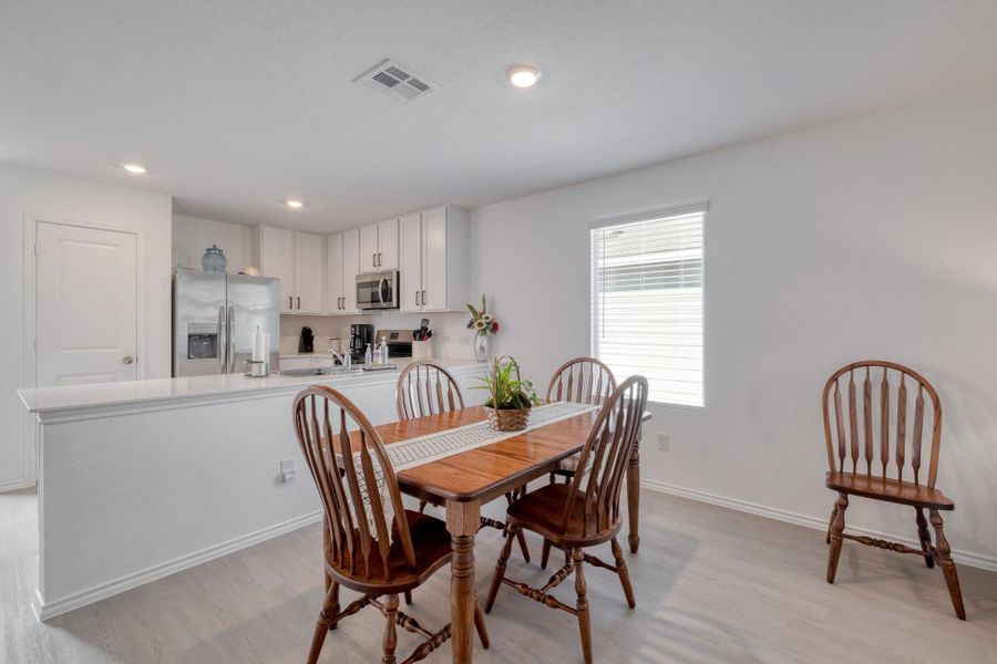 The property features an open-concept living area with a kitchen and dining space