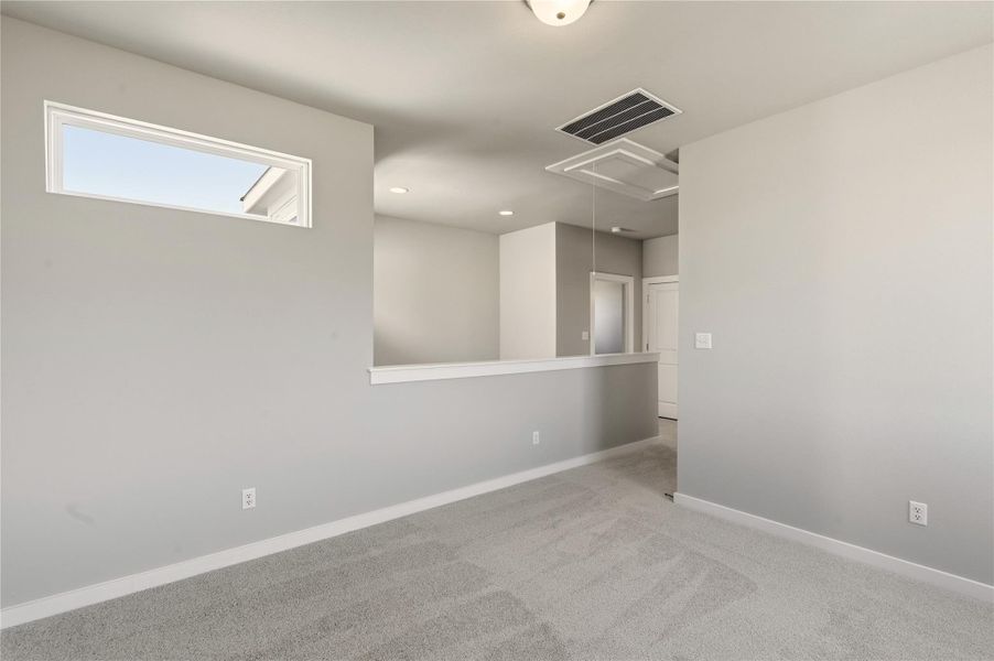 Unfurnished room featuring carpet, attic access, and recessed lighting