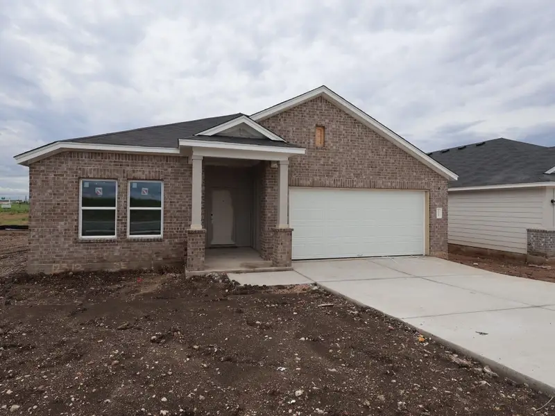 Front exterior of a new home in Willow Springs, Buda, TX, highlighting curb appeal (Image 4).
