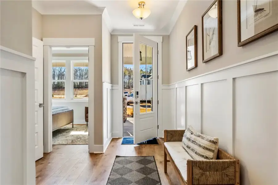 This inviting entryway features warm wood flooring