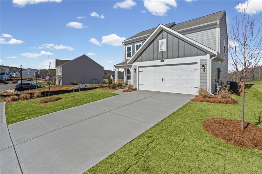 Front exterior of a new home in Twin Lakes, Hoschton, GA, highlighting curb appeal (Image 19). Front exterior of a new home in Twin Lakes, Hoschton, GA, highlighting curb appeal (Image 19).