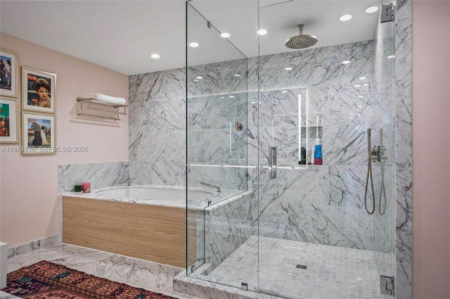 Primary bath with oversized marble shower and Roman tub