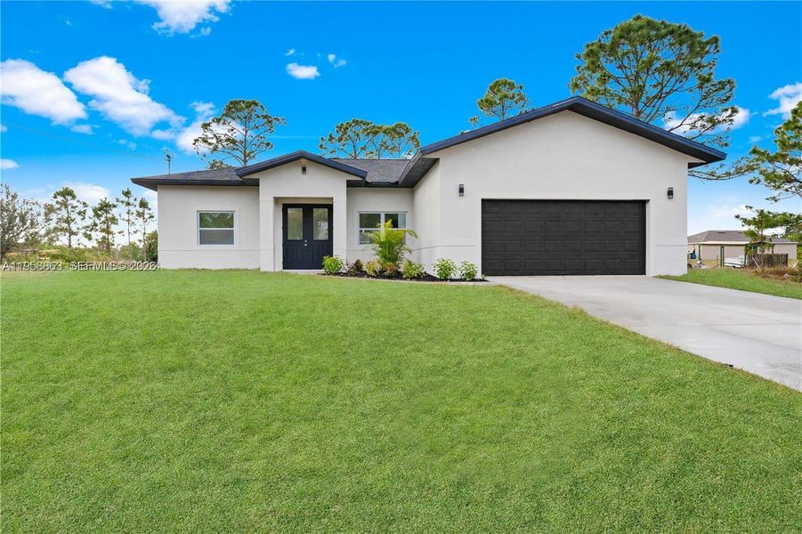 Front exterior of a new home in , Lehigh Acres, FL, highlighting curb appeal (Image 17). Front exterior of a new home in , Lehigh Acres, FL, highlighting curb appeal (Image 17).