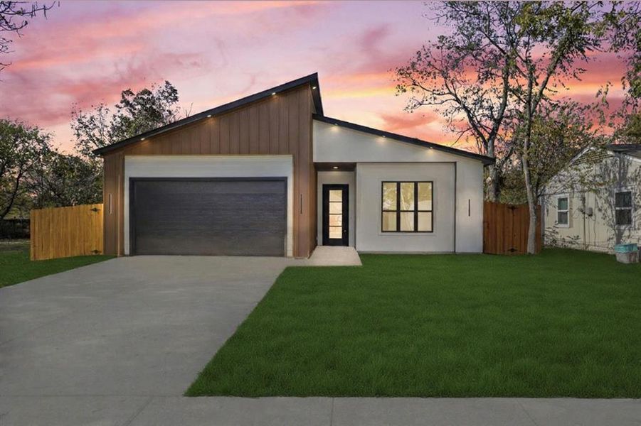 View of front of house with driveway, an attached garage, and stucco siding