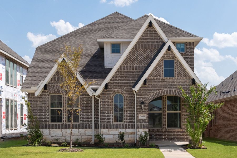 Front exterior of a new home in Wildflower Ranch, Justin, TX, highlighting curb appeal (Image 1). Front exterior of a new home in Wildflower Ranch, Justin, TX, highlighting curb appeal (Image 1).