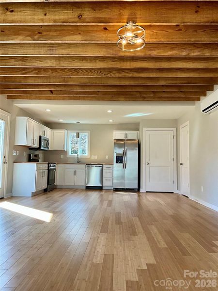 Open beams in livingroom.  Open concept kitchen and living room