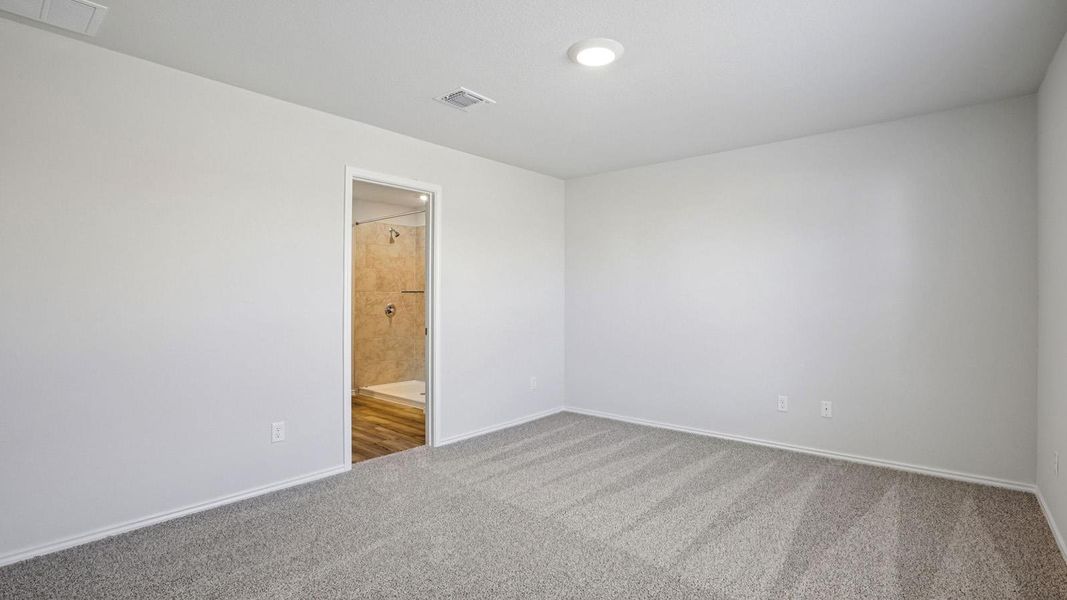 Spare room with light carpet and baseboards