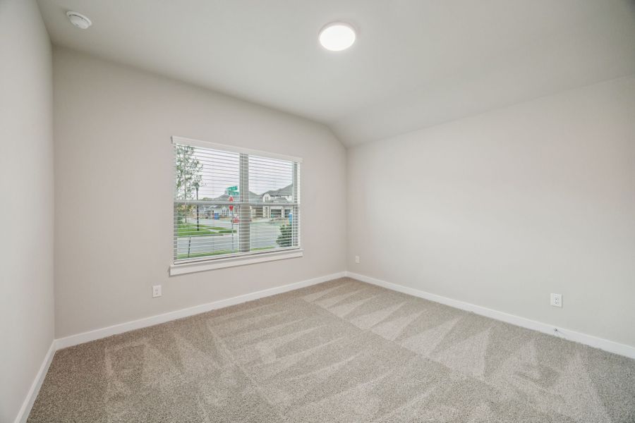 Bedroom in the Oscar home plan by Trophy Signature Homes – REPRESENTATIVE PHOTO