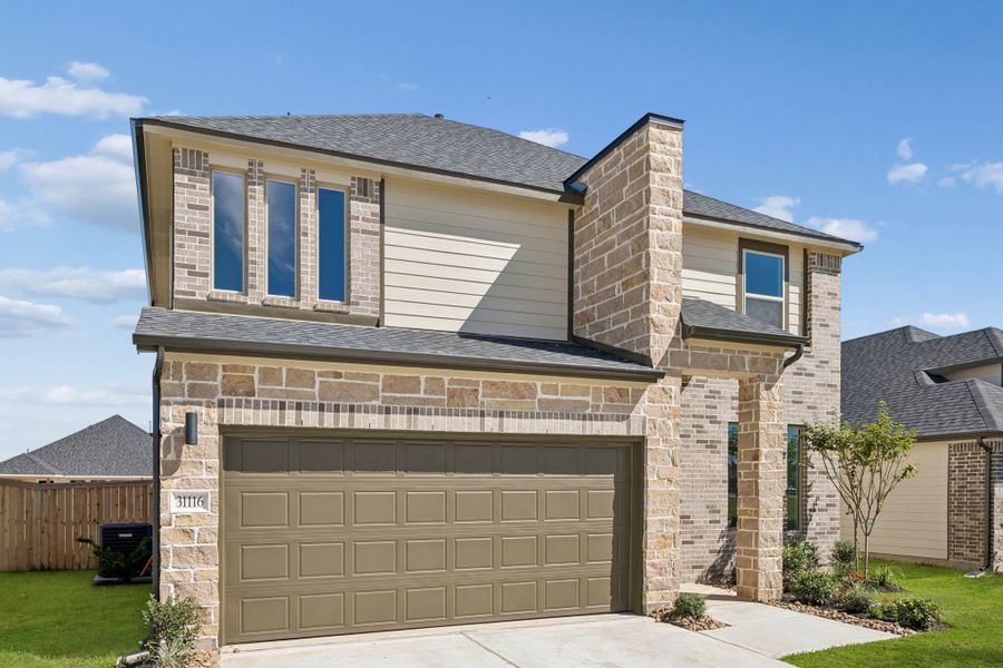 Front exterior of a new home in Riviera Pines, Huffman, TX, highlighting curb appeal (Image 2). Front exterior of a new home in Riviera Pines, Huffman, TX, highlighting curb appeal (Image 2).