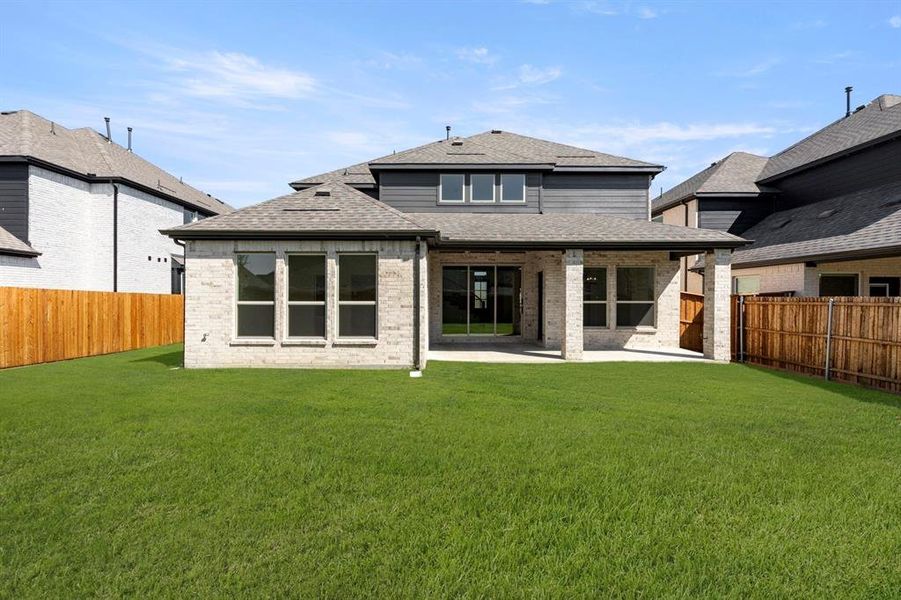 Exterior details and patio area of a home in Valencia on The Lake, Little Elm (Image 22).