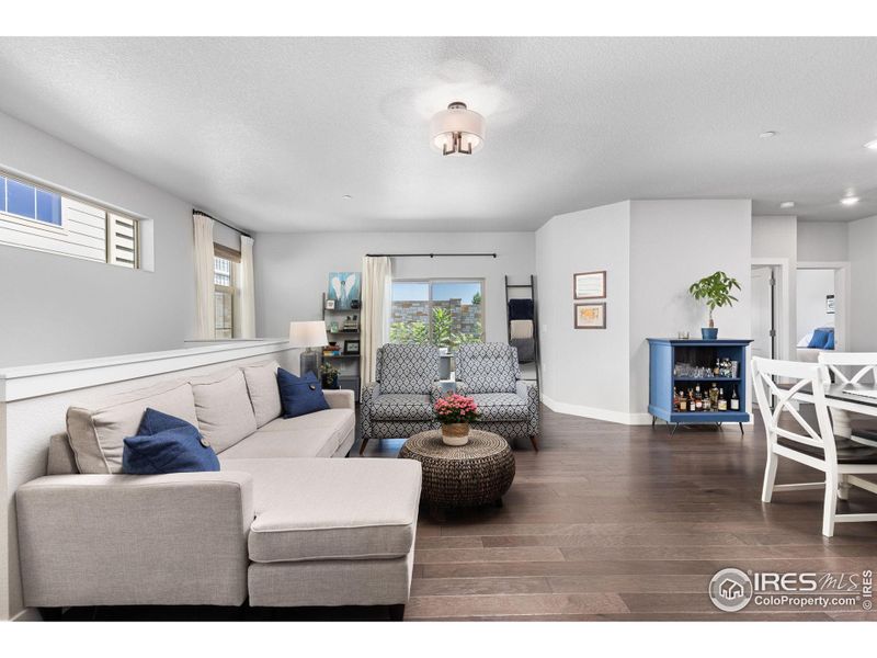 Spacious living area with hardwood floors.