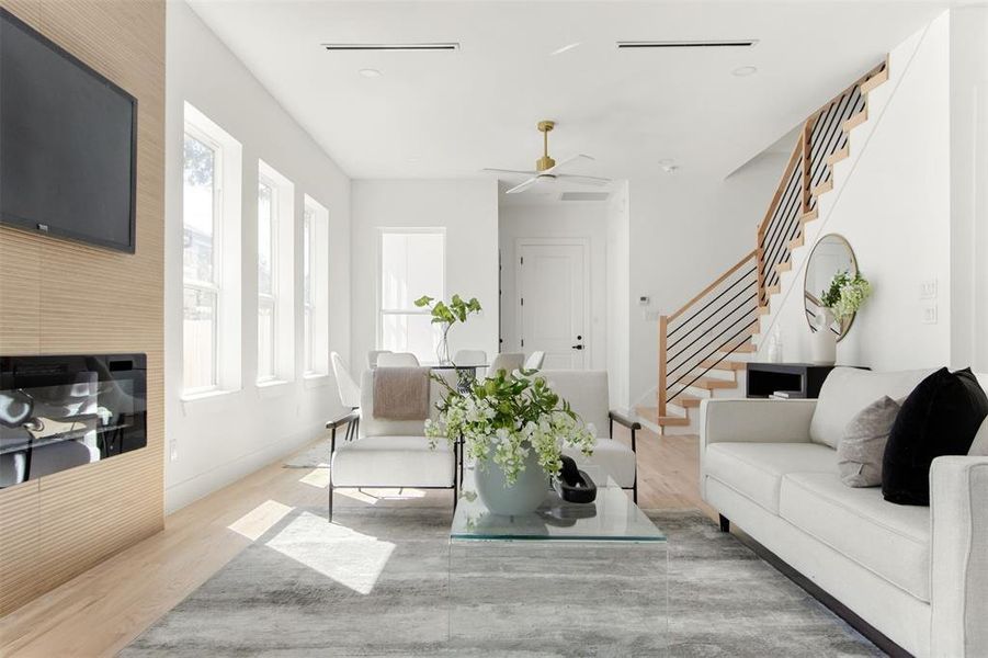 Living room featuring ceiling fan and light hardwood / wood-style floors