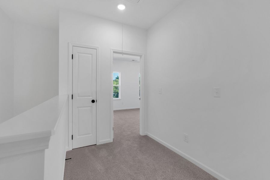 Wide hallway leads to bedrooms on third floor Wide hallway leads to bedrooms on third floor