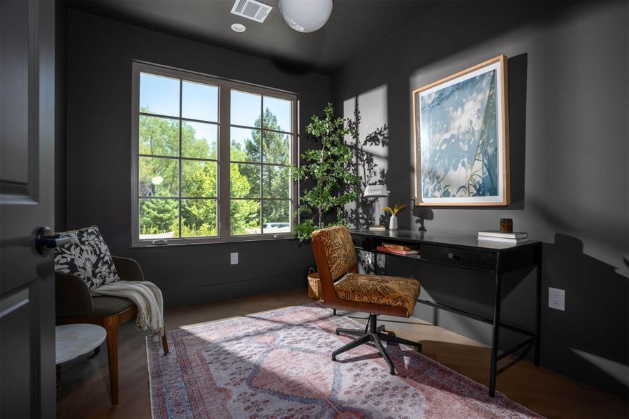 Dramatic dark walls contrast beautifully with warm hardwood flooring and multi-pane windows. Dramatic dark walls contrast beautifully with warm hardwood flooring and multi-pane windows.