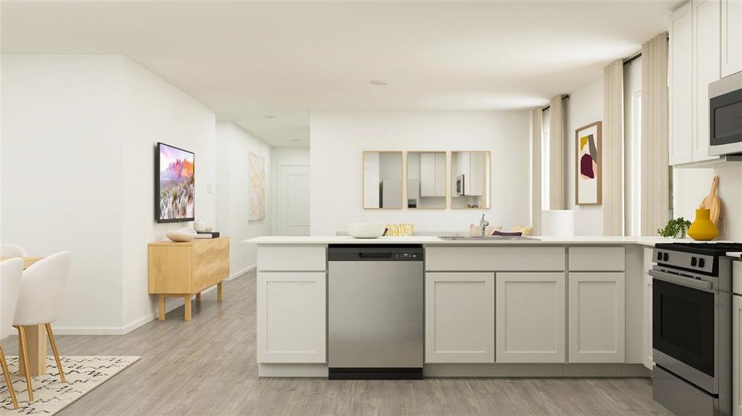 Kitchen featuring kitchen peninsula, appliances with stainless steel finishes, light wood-type flooring, sink, and white cabinetry