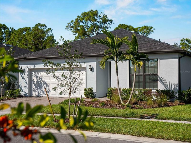 Front exterior of a new home in , North Port, FL, highlighting curb appeal (Image 25). Front exterior of a new home in , North Port, FL, highlighting curb appeal (Image 25).