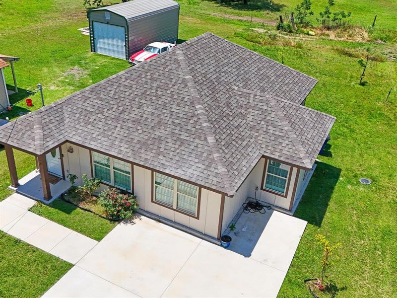 Single-story residence featuring a shingle roof and light-colored siding with dark trim