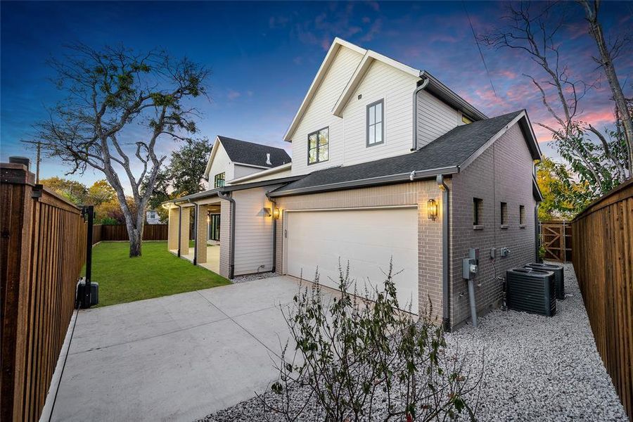 Modern two-story residence featuring light siding and a dark shingle roof